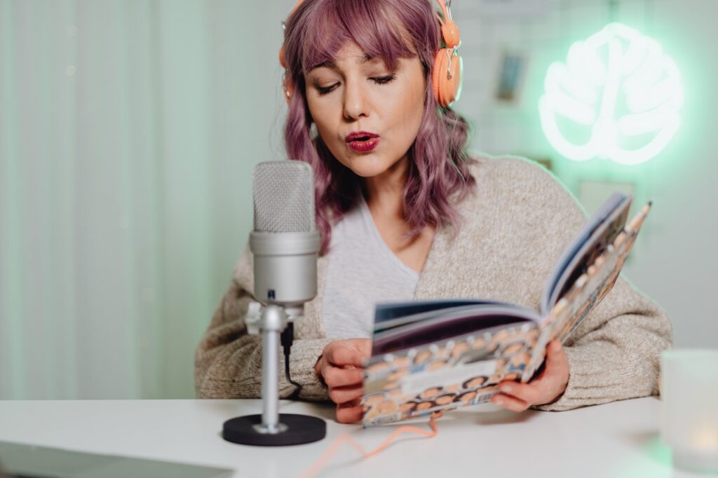 Woman recording a sponsored host read for her podcast