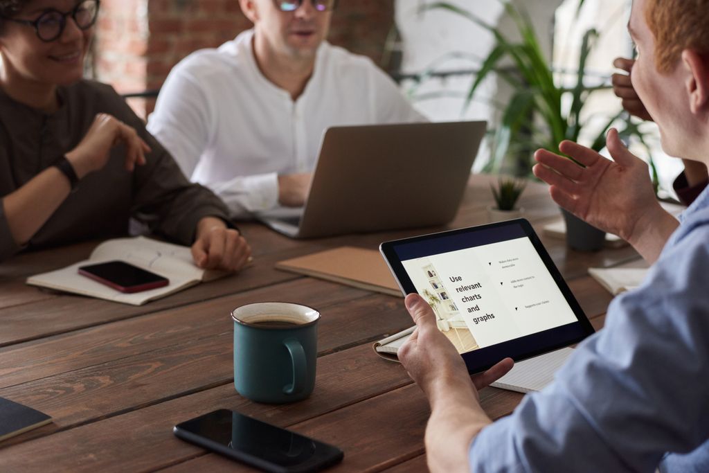 Professionals engage in a collaborative meeting with digital tools, fostering teamwork and innovation.